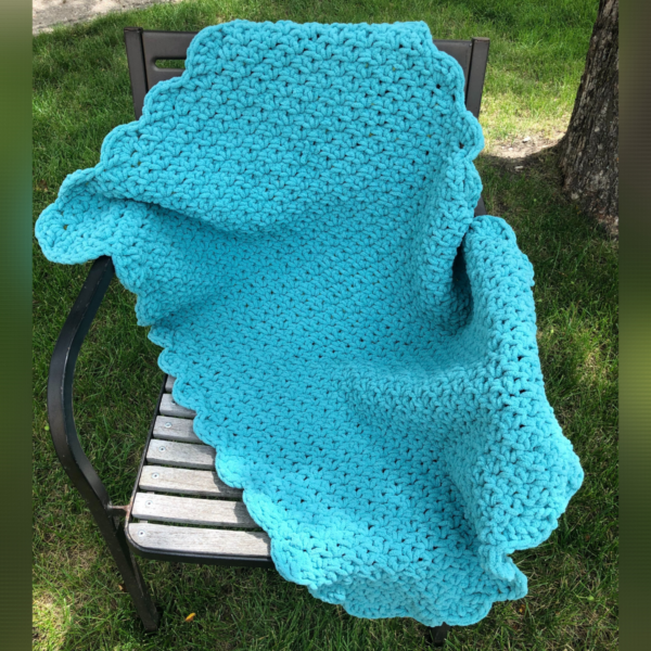 Blue baby blanket crocheted with bulky soft yarn